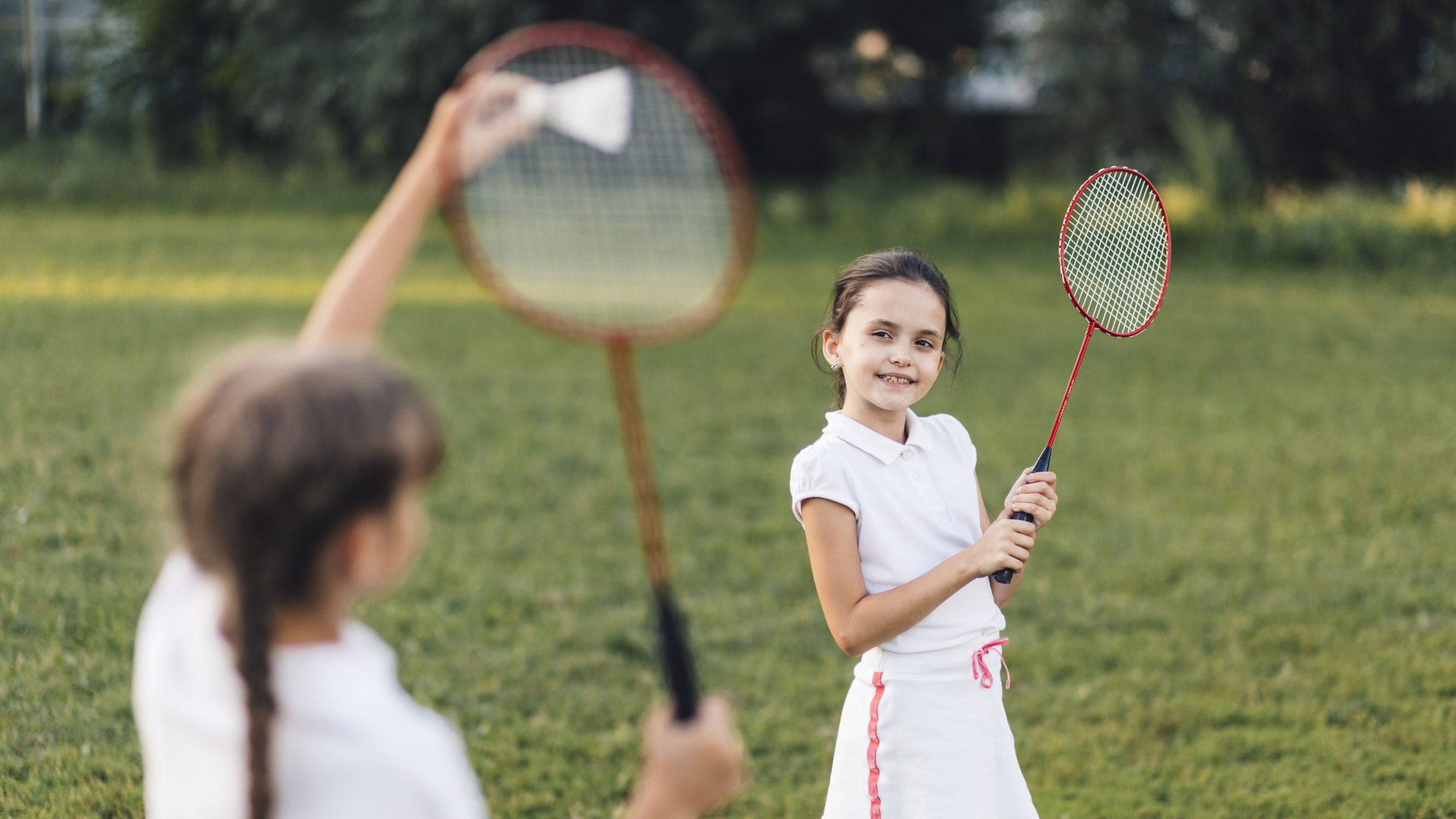 Fete jucând badminton